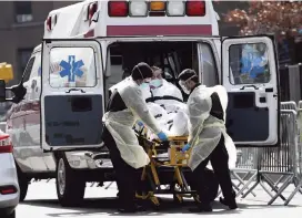  ?? KATHY WILLENS AP ?? A patient is placed in an ambulance at Elmhurst Hospital Center on Tuesday in New York.