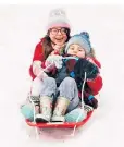  ??  ?? Ivy Mitchel, five, and her brother Albert, three, enjoy the snow in Haverhill, Suffolk