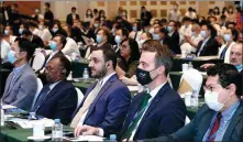  ??  ?? From top: An official gives his view on business at the Singapore session of the seventh Guangzhou Annual Investment Conference. Visitors from China and abroad attend the event last year.