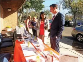  ?? EVAN BRANDT — DIGITAL FIRST MEDIA ?? Stacey Woodland, CEO of YWCA Tri-County Area, explains some of the Y’s initiative­s during the Week Without Violence to U.S. Rep. Ryan Costello, R-6, who stopped by during Thursday’s open house.