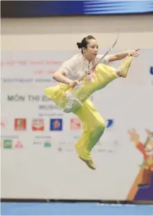  ?? VNA/VNS Photo Quang Hà ?? FLYING KICKS:DƯƠNG Thúy Vi wins a gold medal for Việt Nam in the wushu event yesterday.