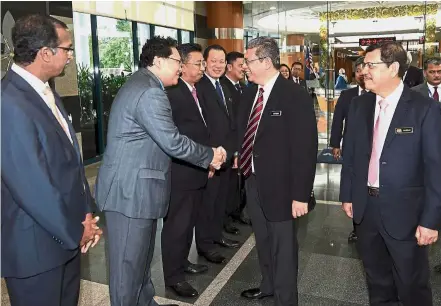  ??  ?? Off to a good start: Saifuddin (second from right) greeting employees of the Foreign Ministry during a welcoming ceremony at Wisma Putra to mark his first day on the job. Looking on is ministry secretary-general Datuk Seri Ramlan Ibrahim (right). —...