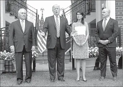  ?? AP/PABLO MARTINEZ MONSIVAIS ?? President Donald Trump, standing (from left) with Secretary of State Rex Tillerson, U.N. Ambassador Nikki Haley and national security adviser H.R. McMaster at Trump’s golf club in Bedminster, N.J., speaks to reporters Friday. “This man will not get...