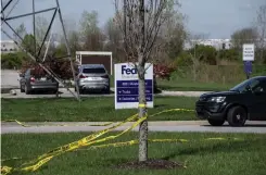  ?? Tribune News Service/getty Images ?? A tree wrapped in caution tape is seen near the parking lot of a Fedex Smartpost on April 16 in Indianapol­is, Indiana.