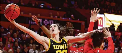  ?? Noah K. Murray/Associated Press ?? Iowa guard Caitlin Clark (22) drives to the basket against Rutgers in January.
