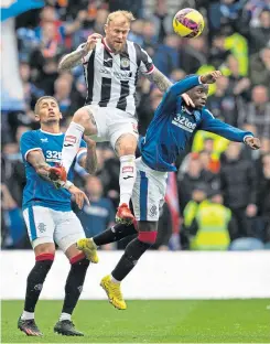  ?? ?? St Mirren’s Richard Tait beats Rangers’ James Tavernier and Fashion Sakala to head clear