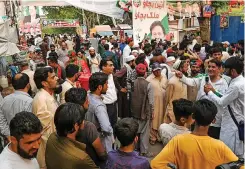  ?? | AFP ?? TEHREEK-E-INSAF Party activists and supporters gather outside Pakistan’s former prime minister Imran Khan’s residence, in Zaman Park in Lahore at the weekend. Khan arrived at his Lahore residence after being freed on bail following days of legal drama and nationwide riots over his arrest on corruption charges.