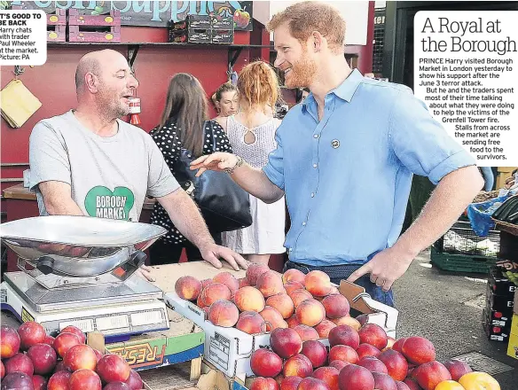  ??  ?? IT’S GOOD TO BE BACK Harry chats with trader Paul Wheeler at the market. Picture: PA