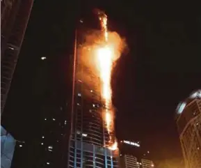  ?? REUTERS PIC ?? Flames shooting up the sides of The Torch residentia­l building in Dubai yesterday.