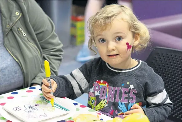  ??  ?? Two-year-old Lilly Menzies at the arts and crafts table during last year’s Lochee Gala Day.