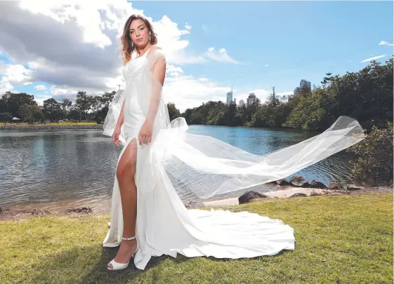  ?? Picture: JASON O'BRIEN ?? Cloe Burke wearing a HollyRose Couture dress ahead of the Gold Coast Wedding Expo at the Gold Coast Convention Centre tomorrow.
