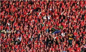  ?? Photograph: David Rogers/Getty Images ?? A couple of South Africa fans amid massed ranks of Lions supporters during the second Test in Pretoria in June 2009.