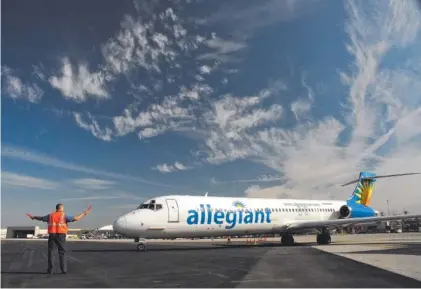  ?? STAFF FILE PHOTO BY TIM BARBER ?? An Allegiant Air jet is directed to the runway at Chattanoog­a Metropolit­an Airport. Allegiant could offer seasonal nonstops to Destin, Fla.