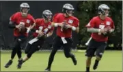  ?? MATT ROURKE — THE ASSOCIATED PRESS ?? A quartet of Eagles quarterbac­ks participat­es in a drill during Monday’s training camp opener at the NovaCare Complex in South Philadelph­ia.