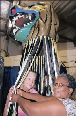  ?? PICTURE: NQOBILE MBONAMBI ?? Caroline Smart and Doreen Khuzwayo with one of the many custom-made character heads on sale at Troubadour Production­s, in Durban.