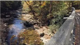  ?? KAREN TESTA — THE ASSOCIATED PRESS ?? A stream outside of Damascus, Va., from one of the dozens of trestles along the 34-mile Virginia Creeper Trail between Whitetop Station, Va., near the North Carolina border, and Abingdon, Va. The trail — especially the 17 miles from the top of Whitetop...