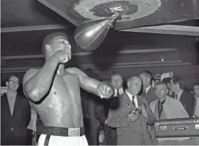  ??  ?? Muhammad Ali works out Feb. 24, 1964, before his first title fight with champion Sonny Liston. Ali defeated Liston twice before Ali’s championsh­ip was stripped. AP