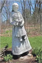  ?? ?? A mother and baby statue is seen at the home of Kathleen Stanislaws­ki and Frank Paul. Stanislaws­ki is restoring the statues before the Friends of Muskego Library Garden Walk.