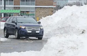  ??  ?? Mountains of snow, such as this one in the Sydney Shopping Centre parking lot, are common sights across Cape Breton following the nor’easter that dumped some 70 cm of snow on the area on Monday and Tuesday. And, the piles are expected to be bigger...