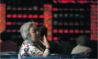  ?? GETTY IMAGES/ FILES ?? An investor reacts as she monitors stock prices at a securities brokerage in Shanghai recently. China’s stock mar kets are the world’s best per form ers this year.