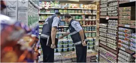  ?? (Bloomberg) ?? Police check prices during a supermarke­t raid in Istanbul, Turkey on Friday