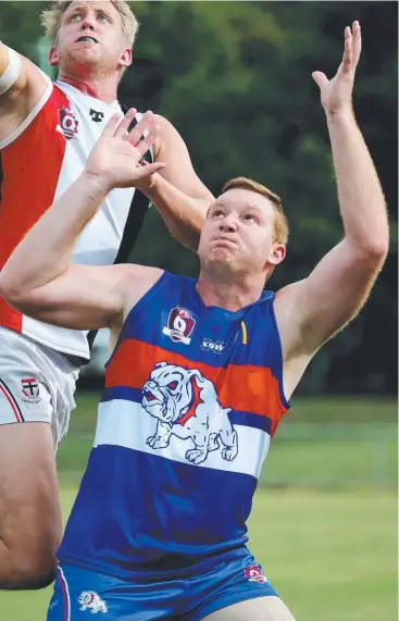  ??  ?? HIGH FLYERS: THE Bulldogs' Michael Chitham during a ruck contest with Cairns Saints big man Adam Davey at Crathern Park. Picture: STEWART MCLEAN