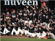  ??  ?? Giants players celebrate after defeating the San Diego Padres to clinch a postseason berth on Monday.