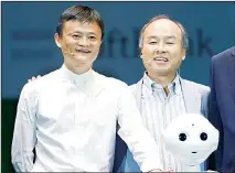  ??  ?? In this file photo, Softbank Corp CEO Masayoshi Son, (right), Alibaba Group Executive Chairman Jack Ma, (left) of China with Foxconn Chairman and CEO Terry Gou of Taiwan (unseen) pose for photograph­ers with Softbank’s Pepper robot during a press conference in Maihama, near Tokyo.
(AP)