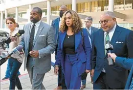  ?? LLOYD FOX/BALTIMORE SUN ?? Baltimore State’s Attorney Marilyn Mosby leaves federal court with her husband Nick Mosby, left, and lawyer A. Scott Bolden, right, on Thursday.