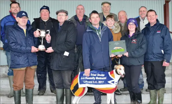  ??  ?? Tim Kennelly, sponsor, presenting the cup to John Quilter, with Mary B Curtin presenting a plaque to Colin Browne after Quilter’s dog, Gone To Town, won the Oaks Trial Stake at the Listowel coursing meeting last Friday. Photo by David O’Sullivan