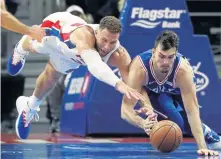  ?? AP PHOTO ?? EXTRA EFFORT: Pistons forward Blake Griffin (left) dives for a loose ball with the 76ers’ Dario Saric last night. Griffin had 50 points in Detroit’s overtime victory.