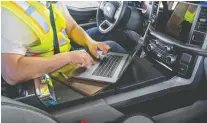  ??  ?? A fold-out platform can serve as a desk in the 2021 Ford F-150. Ford says a third of F-150 owners use a laptop in their trucks.