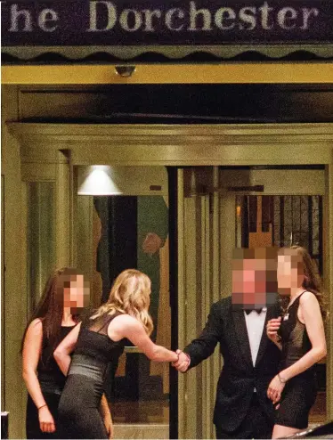  ??  ?? Scandal: A guest outside the Presidents Club gala is greeted by three women