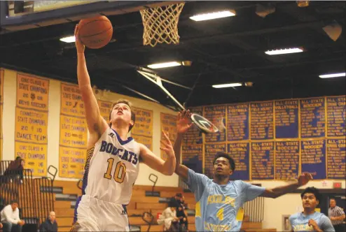  ?? Christian Abraham / Hearst Connecticu­t Media ?? Brookfield’s David Walker, left, lays up the ball as Kolbe Cathedral’s Jaden McLellan defends during Tuesday’s game in Brookfield. Walker scored nine of his 15 points in the final eight minutes.