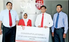  ??  ?? CA Sri Lanka President Jagath Perera presenting the scholarshi­p to Aqeela Izwer of St. Paul’s Girls school, Milagiriya, who was adjudged island third in the commerce stream at the 2017 GCE Advanced Level exam. Also in the picture are CA Sri Lanka Vice...