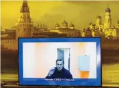  ?? ALEXANDER ZEMLIANICH­ENKO/ASSOCIATED PRESS ?? Russian opposition leader Alexei Navalny appears on a TV screen during a live session with the court during his appeal Thursday for his release from jail.