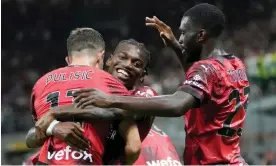  ?? Torino. Photograph: Luca Bruno/AP ?? Rafael Leão (centre) lifts Christian Pulisic in the air after the American scored against