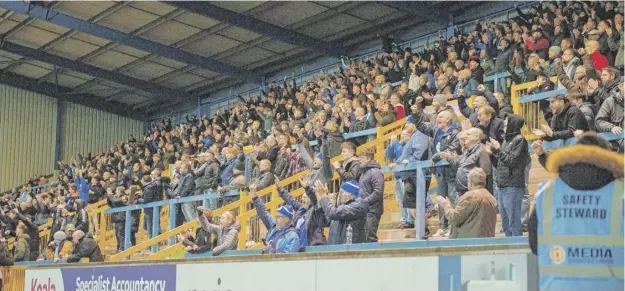  ?? ?? HANDS UP WHO’S EXCITED: Halifax fans at The Shay on Tuesday night during the 1-0 win over Bromley. Photo: Marcus Branston.