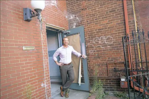  ?? Pam Panchak/Post-Gazette ?? James Haluszczak, founder and managing partner of SteelBridg­e Labs, opens the front door of what will be the company’s new location on Smallman Street in the Strip Disrict.