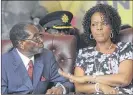  ?? TSVANGIRAY­I MUKWAZHI / AP ?? Grace Mugabe (right), wife of Zimbabwe President Robert Mugabe (left), is accused of assaulting a young model.