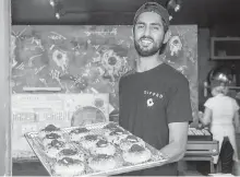  ?? CP ?? Jiten Grover, owner of Dipped Donuts in Toronto, signed up with the Node app to boost foot traffic and sales at his new business.