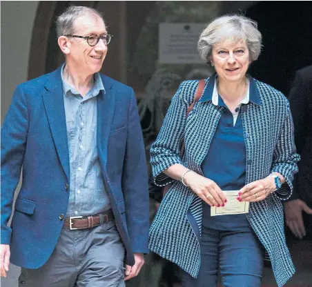  ?? Picture: DAVID HARTLEY ?? Prime Minister Theresa May and husband Philip smile as they leave church in Maidenhead, Berkshire, yesterday