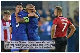  ?? ?? Chippenham Town’s players celebrate their FA Cup first round victory, with Lincoln City’s former Brewer Charles Vernam looking fed up.