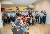  ??  ?? Taranaki police officers and support staff pose for a picture with hairdresse­rs and teenage cancer sufferers after a mass head shaving at Centre City.