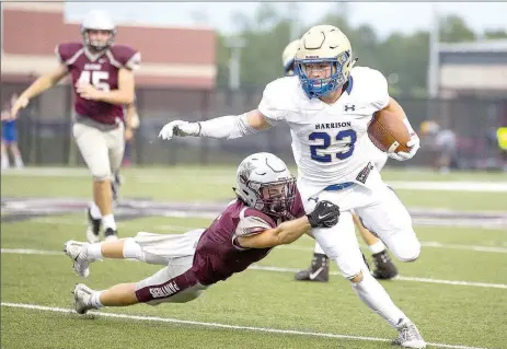  ?? David Beach/Special to Siloam Sunday ?? Gabe Huskey of Harrison runs the ball against Siloam Springs as Elijah Coffey attempts to bring him down Friday at Panther Stadium. Huskey scored five of Harrison’s six touchdowns in a 42-7 Goblins win.