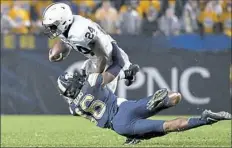  ?? Matt Freed/Post-Gazette ?? Penn State running back Miles Sanders carries against Pitt defensive back Damarri Mathis in the second quarter Saturday at Heinz Field.