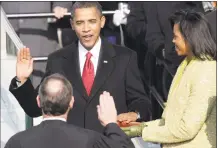  ?? Jae C. Hong / Associated Press ?? In this Jan. 20, 2009, file photo, Barack Obama, joined by his wife, Michelle, takes the oath of office from Chief Justice John Roberts to become the 44th president of the United States at the U.S. Capitol in Washington.