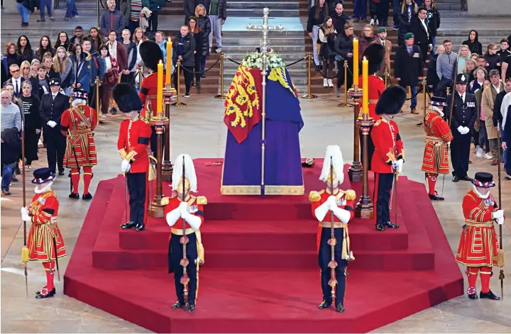  ?? Pictures: REUTERS/HANNAH McKAY/YUIMOK/PA WIRE ?? The final splendour: In solemn silence, the public file past the coffin of Queen Elizabeth II, lying in state in Westminste­r Hall