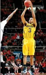  ??  ?? Michigan’s Trey Burke shoots a 3-pointer during the second half against Illinois on Sunday in Champaign, Ill. Michigan took over the top spot after a victory at Illinois on Sunday night. Next up on the schedule is Northweste­rn, and there’s no reason...