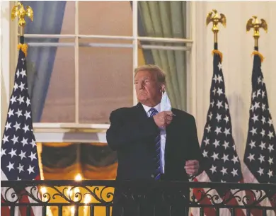  ?? NICHOLAS KAMM / AFP VIA GETTY IMAGES ?? U.S. President Donald Trump arrives at the White House upon his return from Walter Reed Medical Center on Monday.